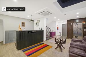 a living room with a couch and a table at Super Townhouse HAL Indiranagar Extension in Bangalore