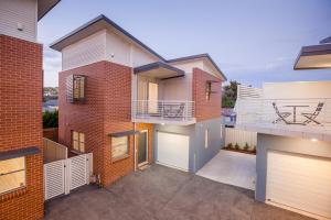 a brick house with a balcony and a garage at Hamilton on Everton in Newcastle