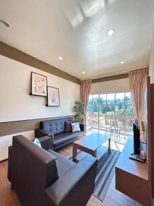 a living room with a couch and a table at Cameron Iris AiSHomestay in Tanah Rata