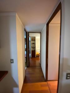 a hallway with an open door to a room at Departamento Las Condes Mall Sport in Santiago
