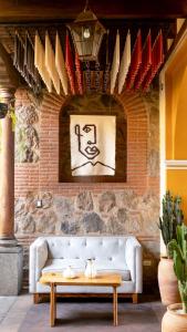 a living room with a white couch against a brick wall at Mestizo Antigua in Antigua Guatemala