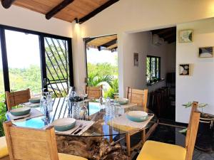 a dining room with a table and some chairs at Casa Namaste del Pacifico - Luxury Villa in Santa Teresa Beach