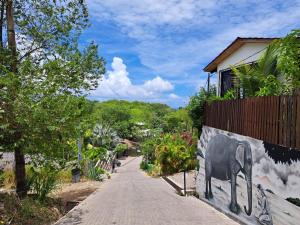 a sidewalk with a painting of a elephant on a wall at Casa Namaste del Pacifico - Luxury Villa in Santa Teresa Beach