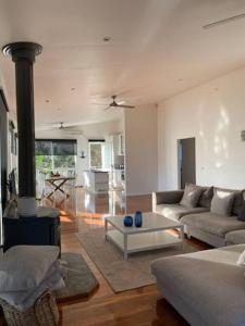 a living room with a couch and a fireplace at Cosy retreat beach house in Rye