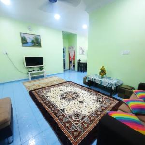 a living room with a rug on the floor at Homestay sunnah bougainvillea resident Islam 