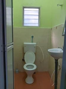 a bathroom with a toilet and a sink at Homestay sunnah bougainvillea resident Islam 