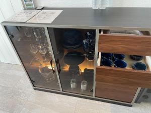 a cabinet with dishes and glasses in it at Premium Villa Miyagijima - Vacation STAY 06499v in Uruma