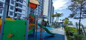 a playground with a slide in front of a building at SAZ Guesthouse in Semenyih