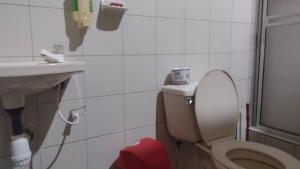 a small bathroom with a toilet and a sink at hotel valparaiso in Ipiales