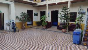 a lobby with potted plants and chairs in a building at hotel valparaiso in Ipiales