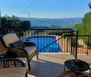 a balcony with a view of a swimming pool at Ithaki House in Lyso