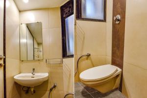 a bathroom with a toilet and a sink at FabHotel RB Residency in Surat
