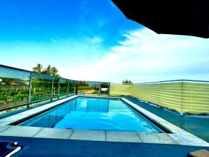 a swimming pool on the roof of a house at Sandy’s Home in Neusiedl am See