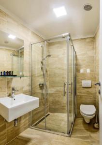 a bathroom with a shower and a sink and a toilet at Sea La Vie Rooms in Novi Vinodolski