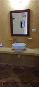 a bathroom with a sink and a mirror at casa YAAKUNAH in Escárcega