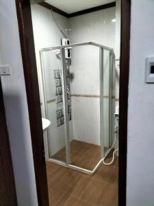 a shower with a glass door in a bathroom at DaViKa Hotel in Vientiane