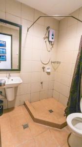 a bathroom with a shower and a sink at Coron Ecolodge in Coron