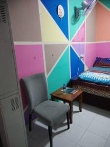 een slaapkamer met een bed, een stoel en een tafel bij Sharaf DG Metro Unisex PARTITION Private room -40-02 in Dubai