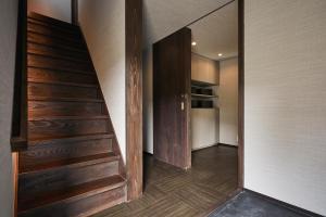 a hallway with a wooden staircase in a house at 京都ミヤマシキテイ in Nantan city