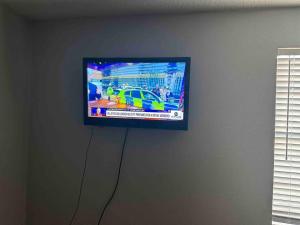 uma televisão de ecrã plano pendurada numa parede em Right next to AT&T Stadium Arlington - Luxury Unit em Arlington