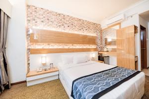 Postel nebo postele na pokoji v ubytování MITC Hotel