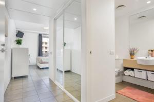 a bathroom with a glass shower and a sink at Marina View Queen Bed Studio Apartment Pool & Gym in Cairns