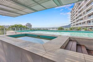 a swimming pool on the roof of a building at Marina View Queen Bed Studio Apartment Pool & Gym in Cairns