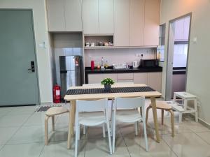 a kitchen with a table and chairs in it at Alpine Parkland Netflix 5 beds at MRT Batu 11 Cheras in Cheras