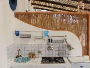 a small kitchen with a stove and a sink at Penelope & Calypso in Acquacalda