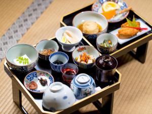 a tray filled with dishes of food on a table at 宿坊　光明院 in Koyasan