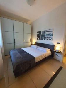 a bedroom with a large bed with two lamps at La casa di Elena Versilia - Two Apartments in Marina di Pietrasanta