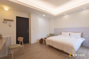 Un pat sau paturi într-o cameră la Muguang Elevator Homestay