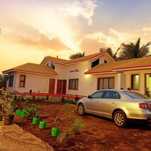 a car parked in front of a house at Suncrest Wood Stayz in Alibaug