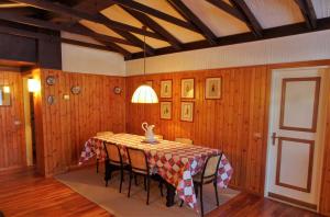 a dining room with a table with chairs and a lamp at Appartamento La Primula in Madesimo +29 photos