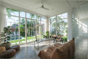 ein großes Wohnzimmer mit Couch und Tisch in der Unterkunft No Rush Villas in Canggu