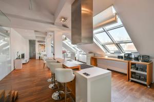 eine Küche mit weißen Arbeitsflächen und einem großen Fenster in der Unterkunft LUXURY CENTRAL PENTHOUSE WITH SAUNA, TERRACE, 250m2, 5BDRM, 3BTHRM in Prag