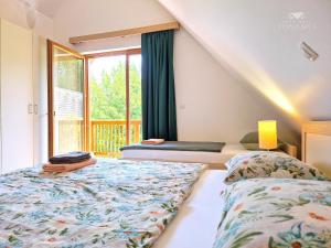 a bedroom with two beds and a window at Apartment DREN near terme Topolšica in Topolšica