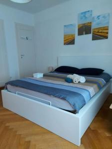a bed in a room with pictures on the wall at 4 minutes from Lausanne Train Station in Lausanne