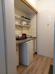 a small kitchen with a counter and a refrigerator at 4 minutes from Lausanne Train Station in Lausanne