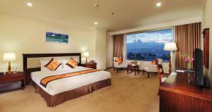 a hotel room with a bed and a large window at Ha Long DC Hotel in Ha Long +54 photos