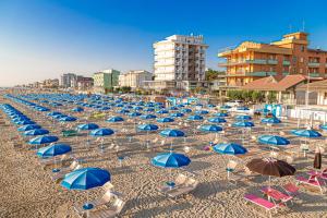a bunch of chairs and umbrellas on a beach at Hotel Cola Frontemare in Bellaria-Igea Marina +69 photos