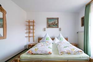 1 dormitorio con 1 cama con 2 almohadas en Gästehaus Aschauer, en Schneizlreuth