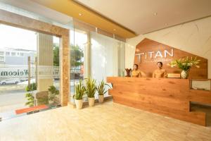 a lobby of a store with a counter with plants at Titan Hotel Da Nang in Da Nang