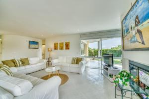 ein Wohnzimmer mit weißen Möbeln und einem Kamin in der Unterkunft Ideal Property Mallorca - Villa Anna in El Port