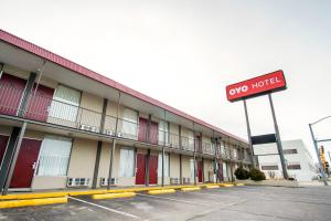 a two hotel sign in front of a parking lot at OYO Hotel Hutchinson KS West 4th Ave in Hutchinson