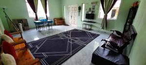 a living room with a drawing on the floor at Homestay Hamdan in Bagan Pulau Betung