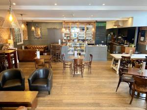 a restaurant with wooden tables and chairs and a bar at The Rest Hotel in Lincoln