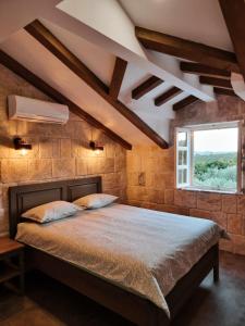 a bedroom with a large bed with a window at NEW 2023 Villa Tree of Life in Sveti Petar
