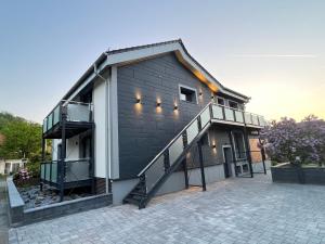 a house with a staircase on the side of it at H-Loft Style Apartments in Bad Lauterberg