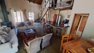 a living room with a couch and a table at Izintaba Private Game Reserve Waterberg in Vaalwater